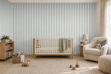 Striped Wallpaper Mural in Gnome Green; green stripes wrapping onto the side wall in a nursery with a wooden crib | Craft Paper Co