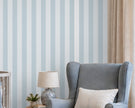 Striped Wallpaper Mural in Pool Blue; close-up of ice blue stripes behind a blue armchair and lamp | Craft Paper Co