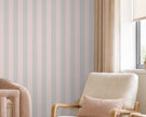Striped Wallpaper Mural in Pink Grey; close-up of pink and gray stripes behind a pink armchair | Craft Paper Co