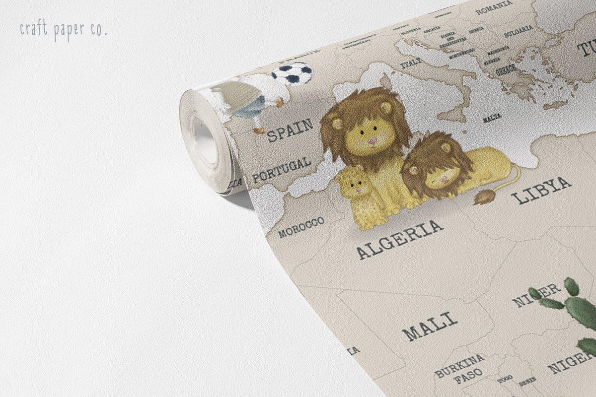 Classic World Map Wallpaper Mural in Greige; unrolled roll showing a lion family, a giraffe and African country names | Craft Paper Co