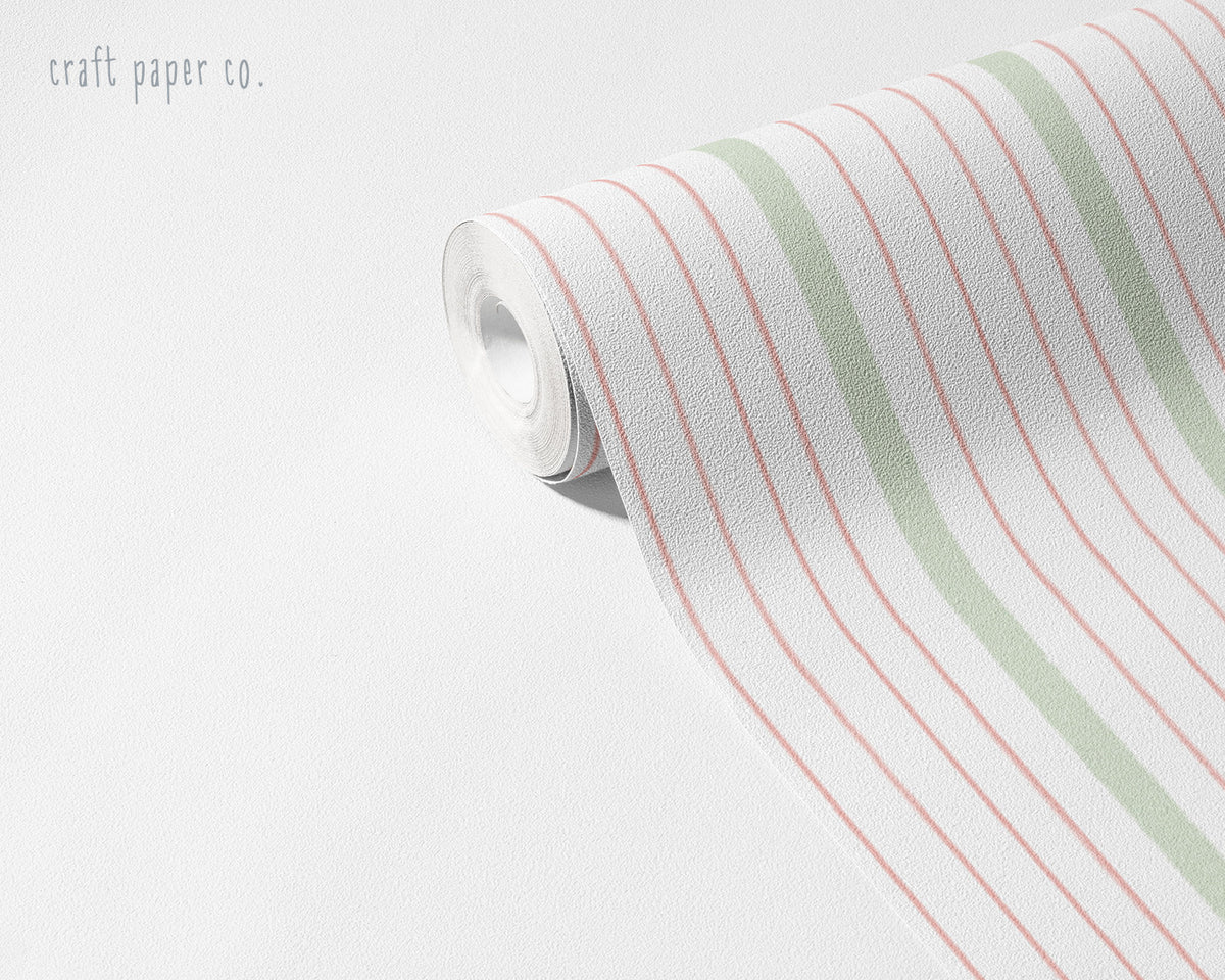 Thin Stripe Wallpaper Mural in Pink Sage; unrolled roll showing thin pink and sage stripes | Craft Paper Co