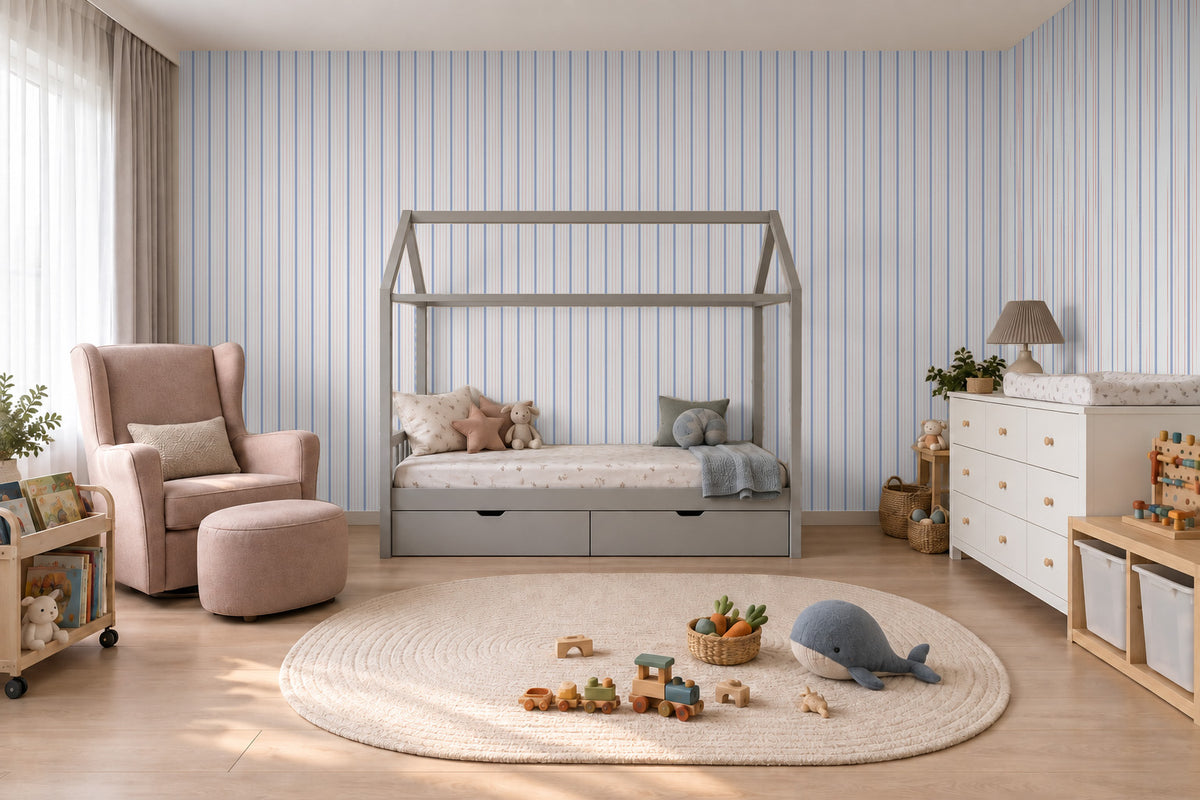 Thin Stripe Wallpaper Mural in Lilac Blue & Red; thin stripes wrapping onto the side wall in a kids' room with a pink armchair | Craft Paper Co