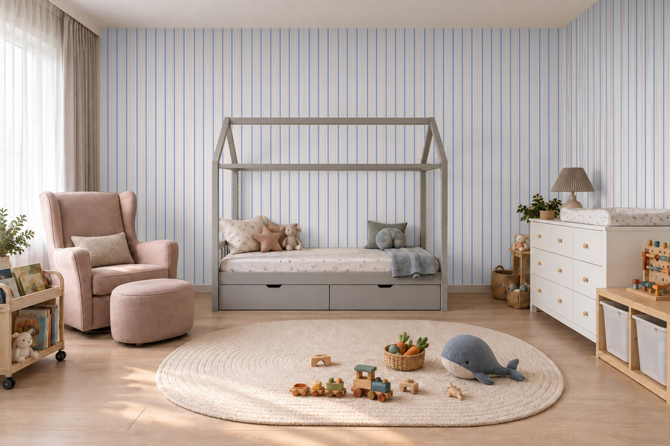 Thin Stripe Wallpaper Mural in Lilac Blue & Red; thin stripes wrapping onto the side wall in a kids' room with a pink armchair | Craft Paper Co