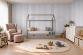 Thin Stripe Wallpaper Mural in Lilac Blue & Red; thin stripes wrapping onto the side wall in a kids' room with a pink armchair | Craft Paper Co