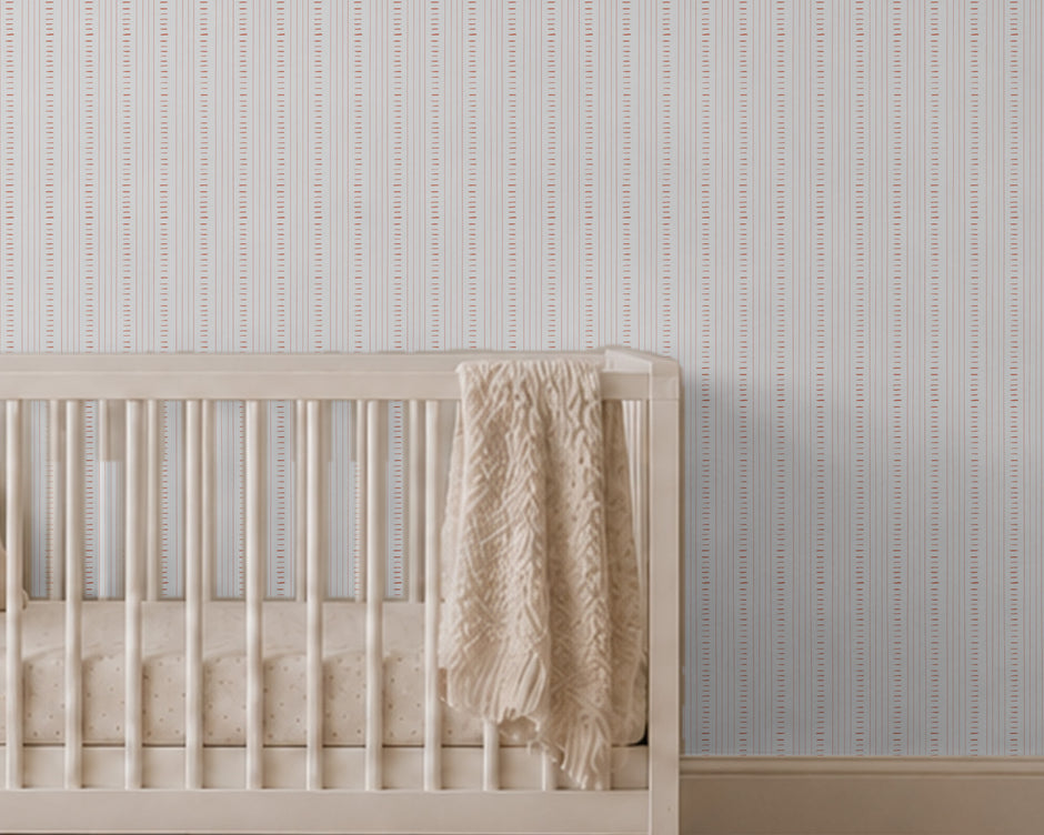 Linen Stitch Wallpaper Mural in Red; close-up of red stitch lines above a wooden crib | Craft Paper Co