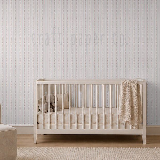 Keten Dikiş çocuk odası duvar kağıdı; pencereli sakin odada beşik üstünde ince kırmızı dikiş çizgileri | Craft Paper Co