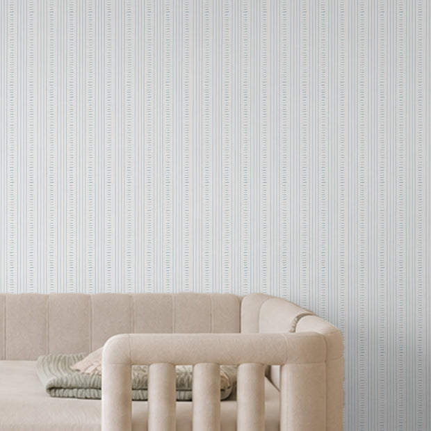 Keten Dikiş Mavi Duvar Kağıdı; krem kanepenin arkasında mavi dikiş çizgilerinin yakın görünümü | Craft Paper Co