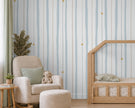 Blue & Beige Starry Stripe Wallpaper Mural; close-up of vertical stripes and stars behind a cream armchair | Craft Paper Co