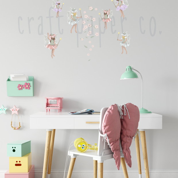 Periler ve Çiçekler Duvar Sticker; beyaz çalışma masasının üstünde duvarda uçuşan periler | Craft Paper Co