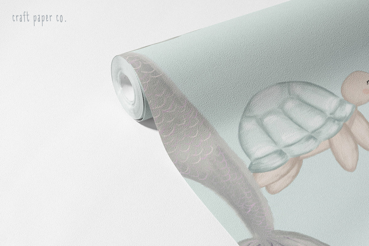 Blonde Mermaid and Friends Wallpaper Mural; unrolled roll showing a mermaid tail and a turtle | Craft Paper Co