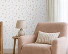 Sweet Mini Flowers Wallpaper Mural; close-up of watercolor mini roses behind a powder pink armchair and lamp | Craft Paper Co