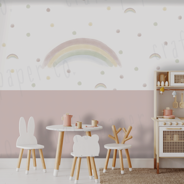 Suluboya Gökkuşağı Ve Puantiyeler Çocuk Odası Duvar Sticker; pembe lambri duvarlı oyun odasında beyaz masa ve oyuncak mutfağın üstünde gökkuşağı | Craft Paper Co